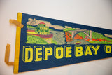 Vintage Depoe Bay felt pennant, showing its left yellow trim, brown ties, and retro graphic.