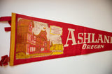 Vintage Ashland Oregon felt pennant, yellow bound edge, red ties, and building graphic.