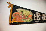 Angled view of a vintage felt pennant showing the bull-carried wagon graphic and lettering.