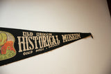 Full-length angled view of the black felt Old Oregon Historical Museum pennant.