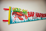 Red felt loops and yellow striped edge of vintage Bar Harbor Maine pennant.