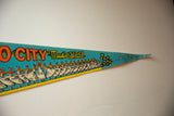 Pointed tip of vintage teal felt pennant, with ballerinas, yellow script, and stars.