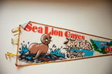 Angled view of the vintage felt flag showing its playful sea lion graphic and red lettering.
