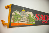 Yellow felt edge and retro graphic detail of Sacramento State Capitol on vintage flag.