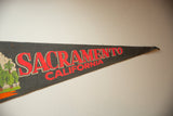 Pointed end of Sacramento California vintage felt pennant, with red text and blue tip.