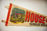 Graphic illustration and bold red lettering on a vintage House of Mystery felt pennant.