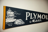 Yellow felt border with visible stitching and dark blue felt texture of the pennant.