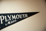 Vintage felt pennant with bold white 'PLYMOUTH Mass.' lettering on dark felt.