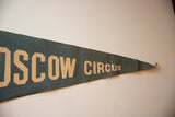 Close-up of the vintage Moscow Circus blue-green felt pennant with beige 'CIRCUS' text and wear.