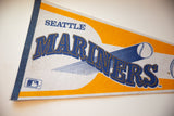 Blue stitched felt edge and SEATTLE text on an aged vintage Mariners pennant.