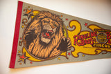 Roaring lion graphic with fangs and claws on vintage Ringling Bros felt banner.