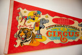 Vintage Tarzan Zerbini felt pennant graphics: retro tiger, trapeze artist, elephant.