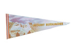 Vintage Mount Rushmore felt flag with photo print, pastel sky, and gold lettering.