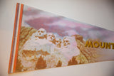 Detail of the photo graphic and striped border on a vintage Mount Rushmore pennant.