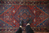 Vintage Hamadan rug: sapphire blue hexagonal medallion with black cherry red serrated field.