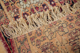 Cream fringe and seamed cochineal red border on the antique Kerman rug.