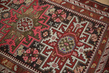 Crab design motif within a geometric starburst medallion, featuring pink, red, and blue patterns.