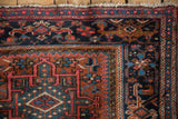 Close-up of Vintage Karaja rug corner, geometric Samovar border, madder red, navy, teal.
