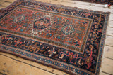 Karaja rug's Samovar main border and field motifs in navy, chestnut, and teal.