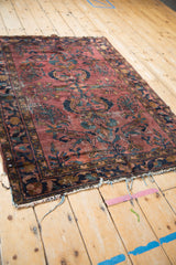 Vintage Lilihan rug detail showing plum and dusty teal floral motifs, abrashed texture.