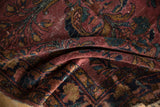 Vintage Lilihan rug detail: hand knotted pile with plum, teal, and copper floral motifs.