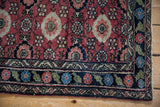 Lilihan rug corner: cherry red field with European-influenced emerald green border.
