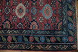 Vintage Lilihan rug detail: cherry red field, unusual emerald green and sapphire border.