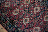 Lilihan rug's cherry red Veramin design, pomegranate motifs, and emerald green border.
