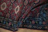 Main border of the vintage Lilihan rug featuring distinctive green, blue, and cherry floral patterns.