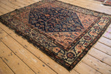 Reciprocating Samovar border and meandering vine motifs on a vintage Malayer rug.