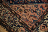 Vintage Malayer rug corner, showing blush field with geometric blossoms, Samovar border, and ivory design elements.