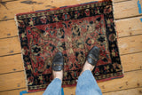 Visible pile loss and threadbare areas on the vintage Lilihan rug's faded floral pattern.