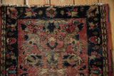 Vintage Lilihan rug fringe and faded brick red, navy blue floral border.