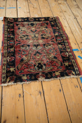Worn texture and faded brick red field with navy border on a vintage Lilihan rug.
