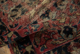 Worn pile of traditional vintage Lilihan rug, faded brick red, navy, and beige floral motifs.