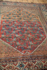 Vintage Malayer rug with cherry red field, geometric vinery, and green-patterned spandrel.