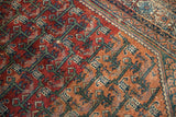 Vintage Malayer rug with geometric vinery, botehs, and jade green outlines on brick red.