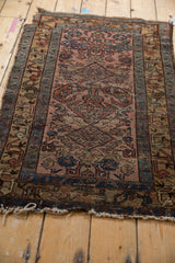 Mehreban rug corner: worn dusty raspberry field, border with bird motifs, hard loss fringe.
