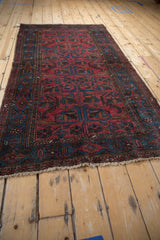 Angled perspective of the Vintage Mehreban rug's allover pinwheel pattern in rich raspberry and sapphire.