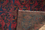Hand-knotted foundation, knot heads, and raspberry red pile of a vintage Mehreban rug.