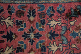 Mostly full pile texture of vintage Lilihan rug, raspberry and indigo blossom pattern.