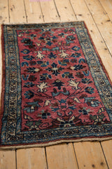 Vintage Persian Lilihan rug detail: raspberry field, vibrant blossoms, powder blue border.