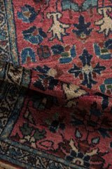 Folded pile of a vintage Lilihan rug, revealing hand-knotted texture and rich hues.