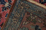 Close-up of vintage Lilihan rug corner with intact side cord, blue, rust, and pink floral patterns.