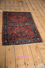 Fringed end, dark navy border, and intricate floral patterns of the vintage Lilihan rug.
