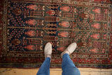 Vintage Kurdish Hamadan rug with botanical garden motif in navy blue, madder red, and blush.