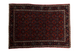 Vintage Persian Engelas rug with an allover Herati design in a rust and deep navy blue palette.