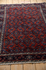 Angled view of the vintage Persian Engelas rug's plush wool and detailed Herati motif.
