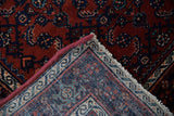 The secured, machine-bound edge and hand-knotted foundation of a vintage Persian Engelas rug.