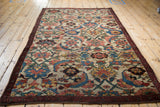 Antique Kurdish Bijar rug corner detail showing Herati Mahimahi motif and burgundy border.